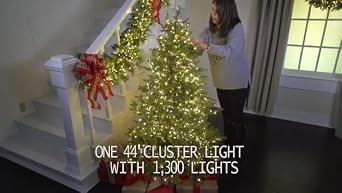 Connectable Cluster Garland Green Wire with 600 White Lights illuminating a festive Christmas tree and staircase garland.