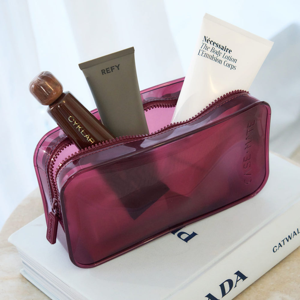 Case-Mate Jelly Makeup Bag in translucent purple, filled with beauty products from Cyklap, Refy, and Necessaire.