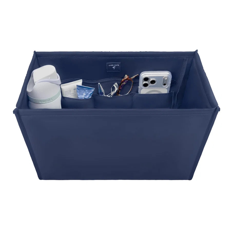Case-Mate Tote Organizer in navy blue, holding an Owala bottle, sunscreen, glasses, and a phone in its compartments.