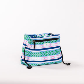 SCOUT Glam Squad Makeup Bag with blue, green, and pink striped pattern, featuring a zipper pocket and drawstring closure.