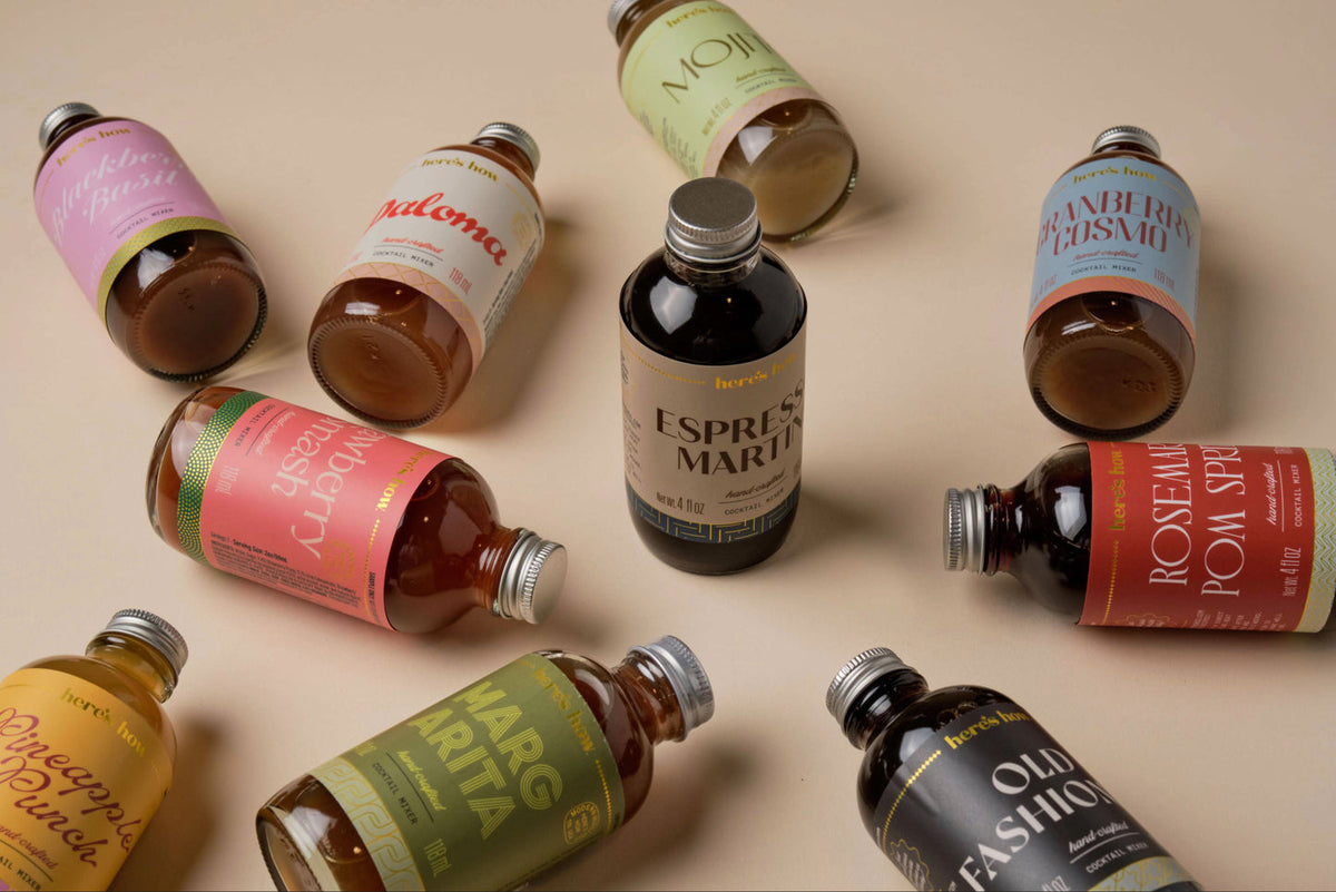 Here's How mini cocktail mixers in glass bottles, showcasing various botanical and classic flavors. Related to 'Set of 3 Mini Mixers, Botanical'.